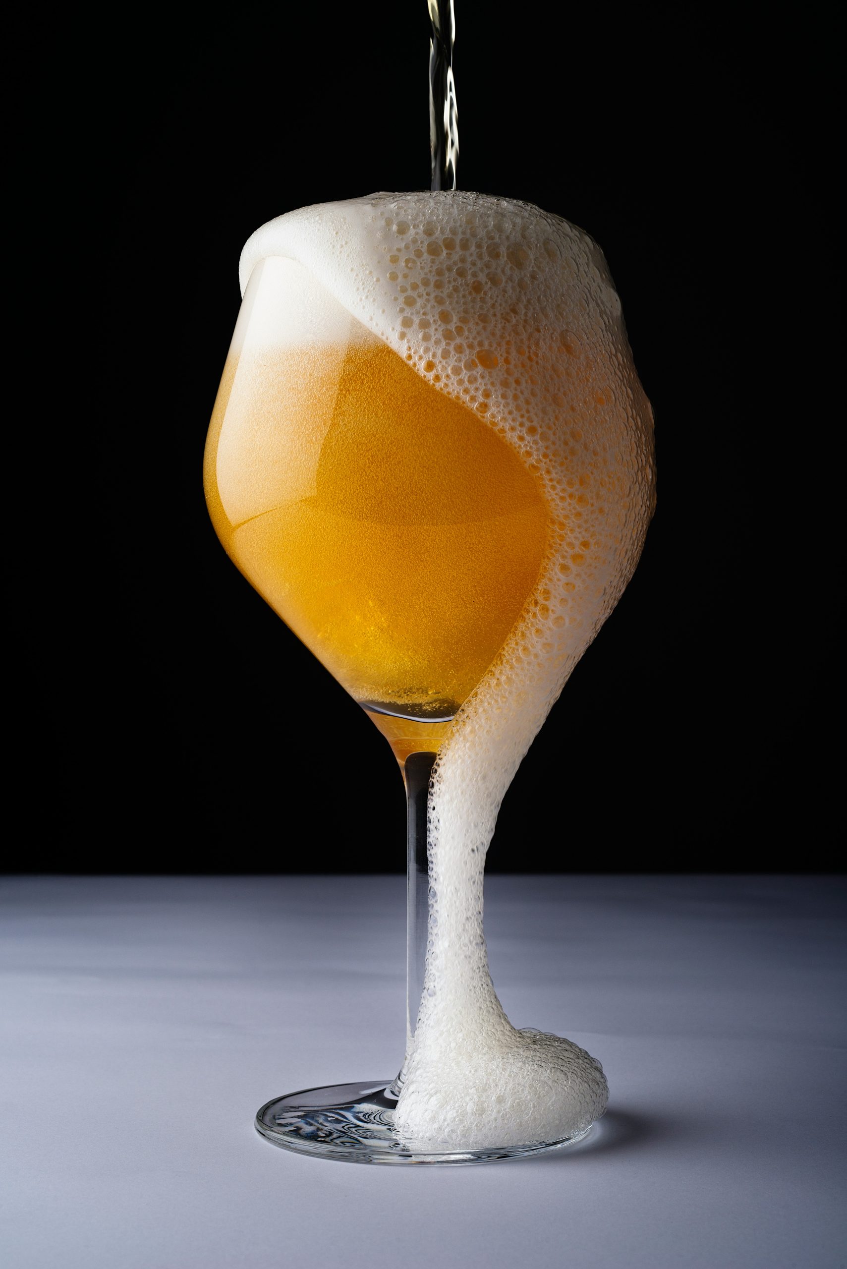 A beermosa cocktail with wine overflowing out of the glass