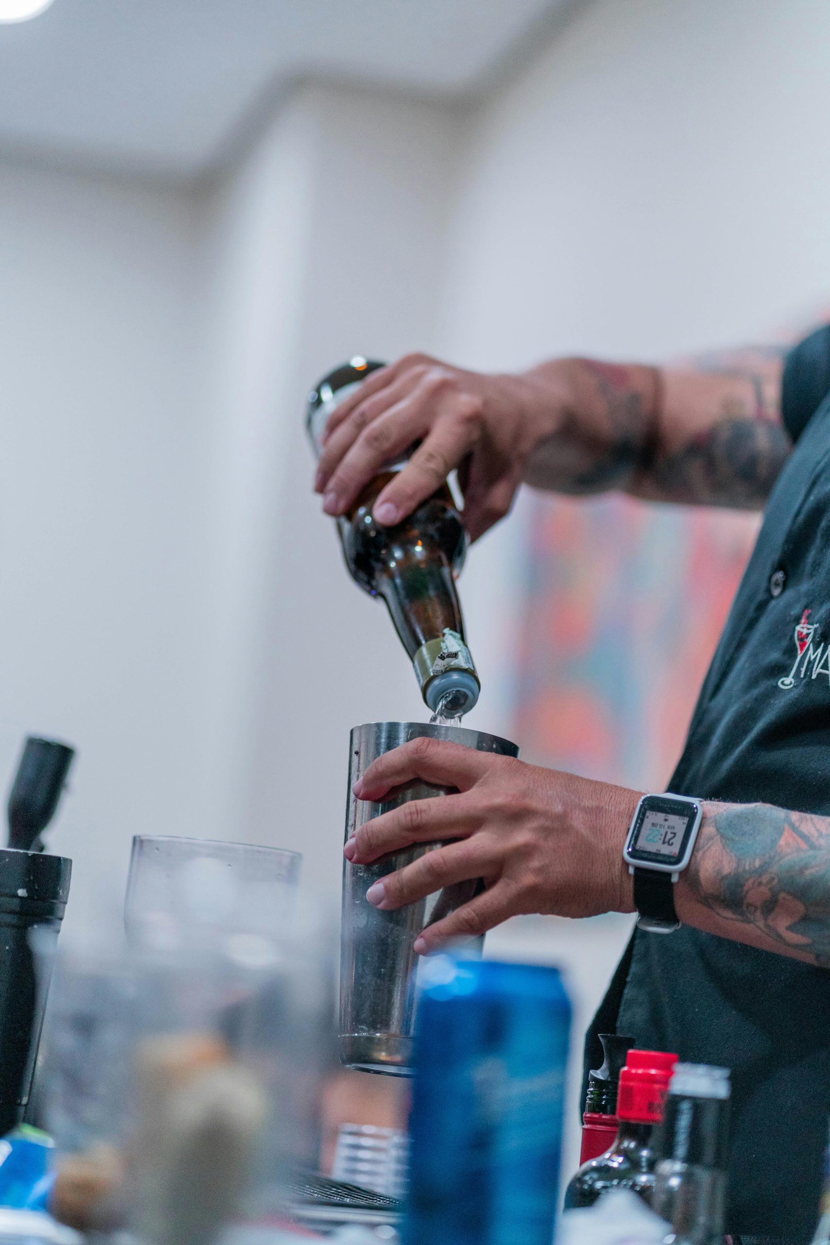 A man pouring into a cocktail shaker