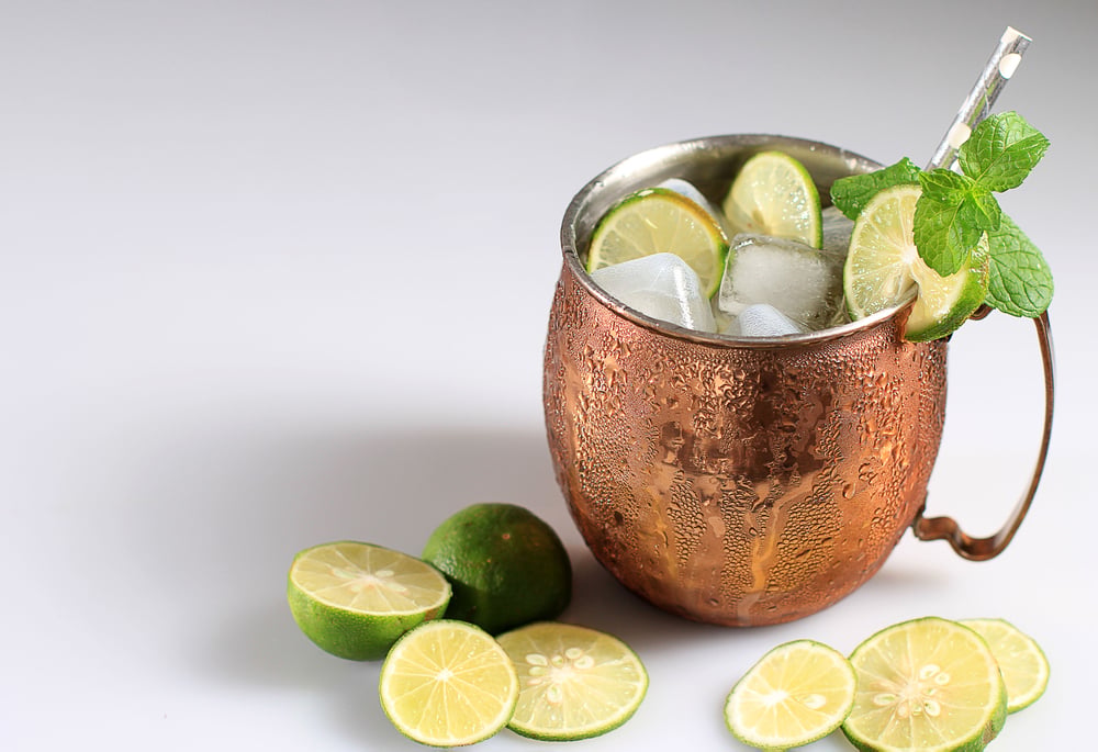 Mexican Moscow Mule Ice Cold Cocktail in Copper Cup with Lime and and Mint