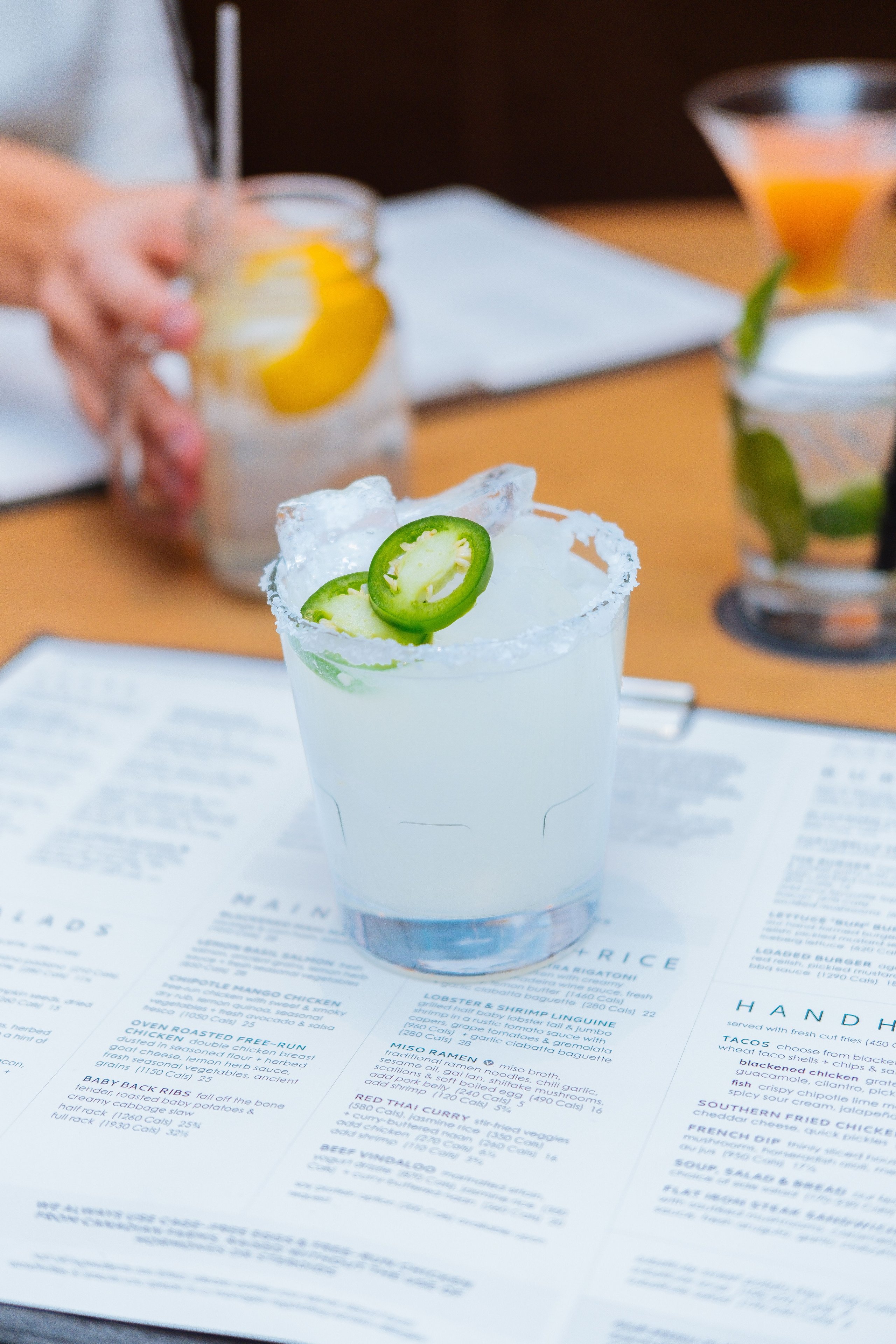 Vodka mule on a table with salt rim and jalepeno slices